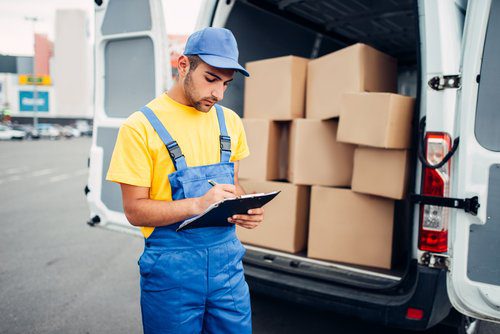 Delivery worker takes inventory of credential clothes shipment