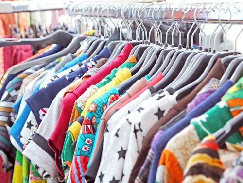 Rack of vintage clothing for sale at thrift store