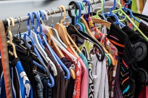 An assortment of dresses and women's tops hanging on a rack