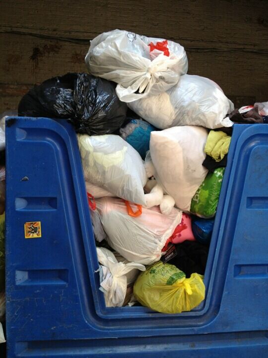 Full donation bin of used clothing