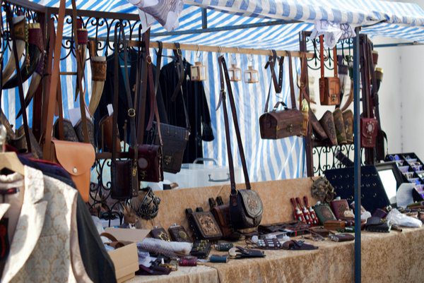 Belts, bags, and other textiles being sold in a market