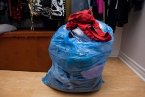 bad og used clothing ready to be donated from closet