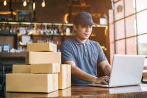 retail owner prepares boxes for shipment