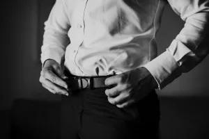 A man buckling his belt