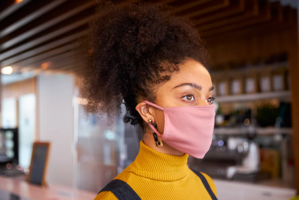 African woman wearing mask made of upcycled textiles