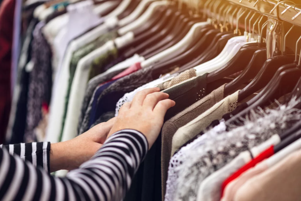 A woman browsing through second hand clothing