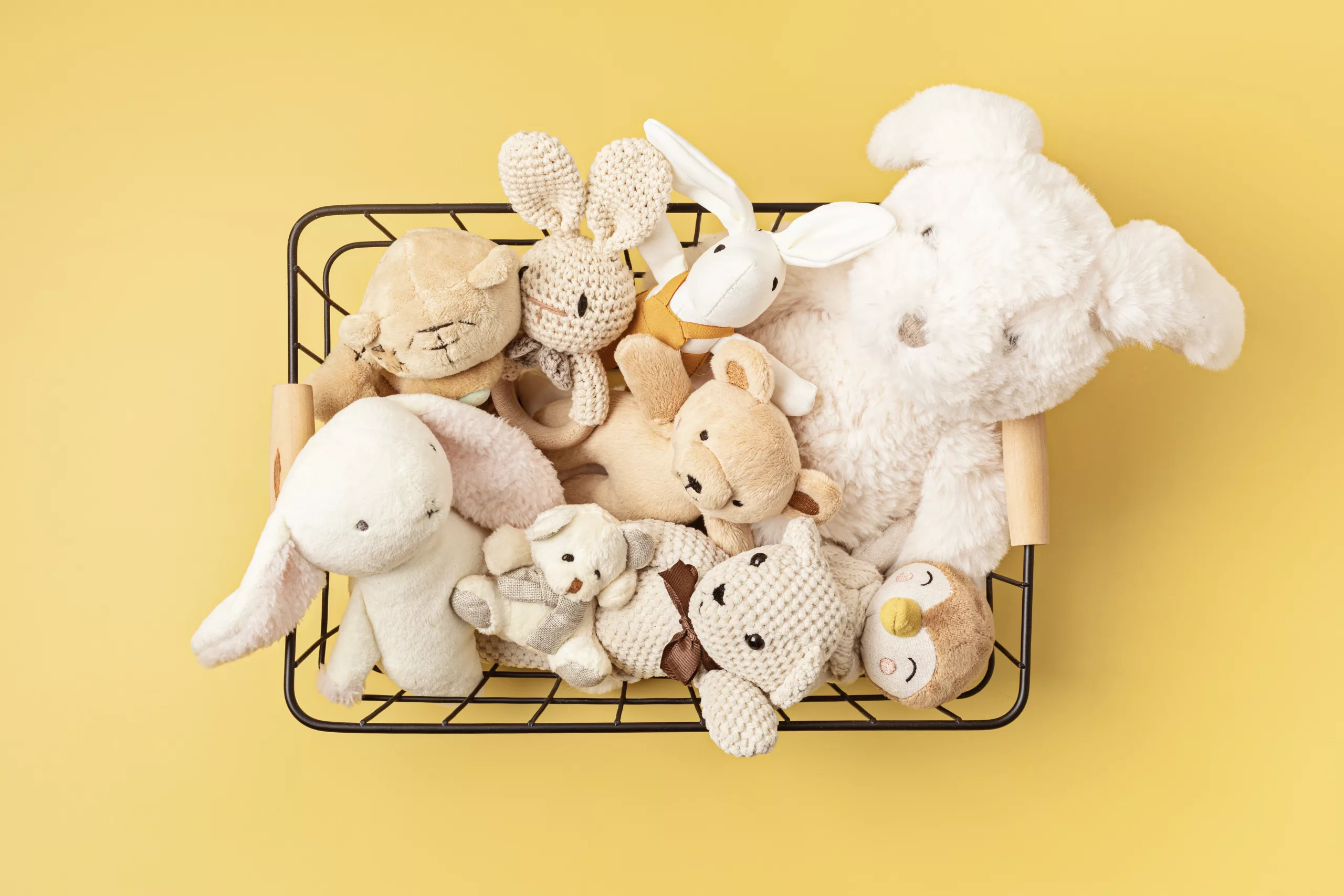 Soft plush used children toys in the basket.