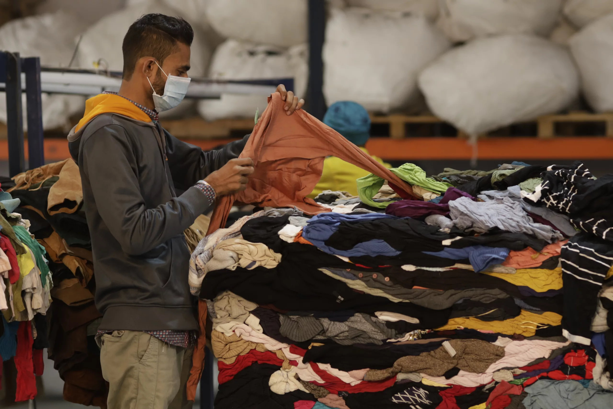 A man grading goods in a warehouse