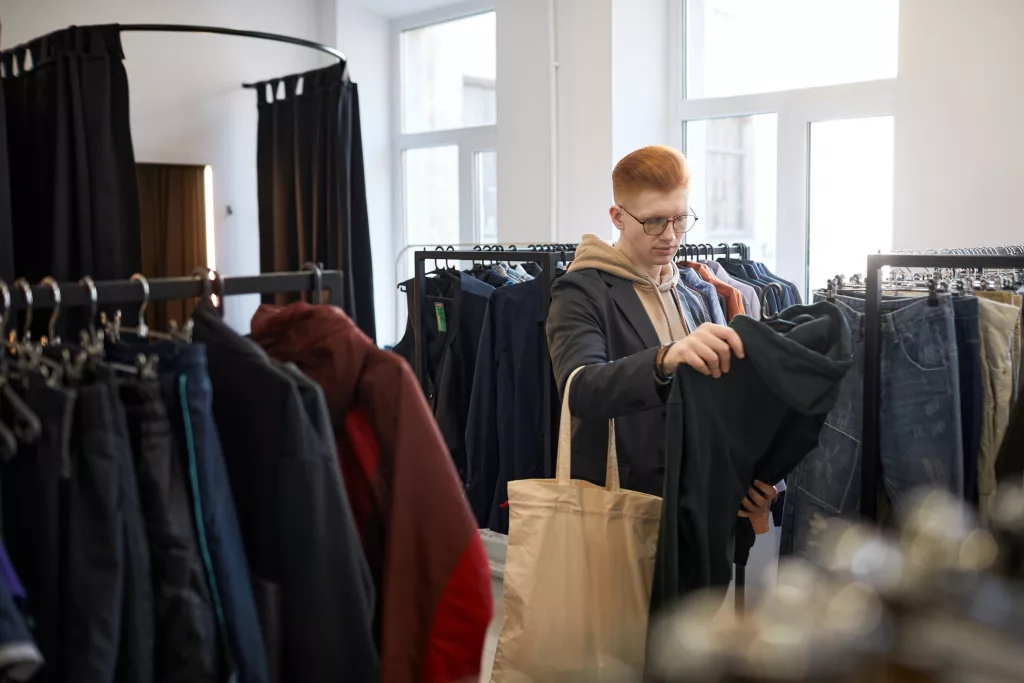 Young man shopping in thrift shop