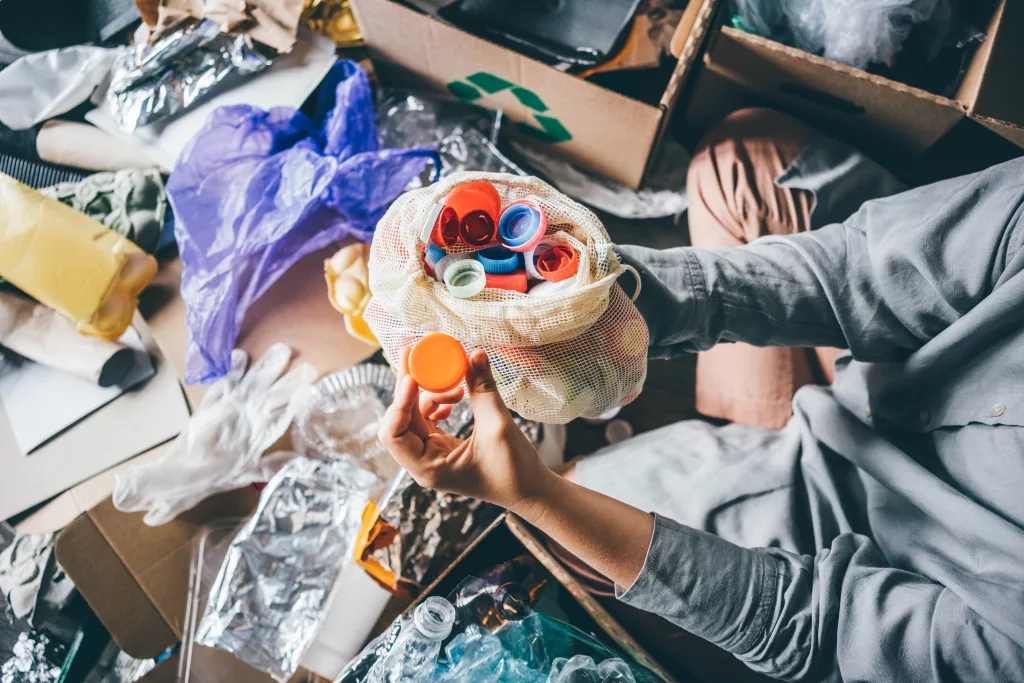 A woman sorting through plastic waste