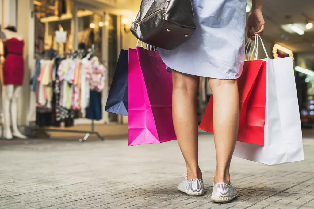 Young woman with shopping bags walking and shopping in the shop