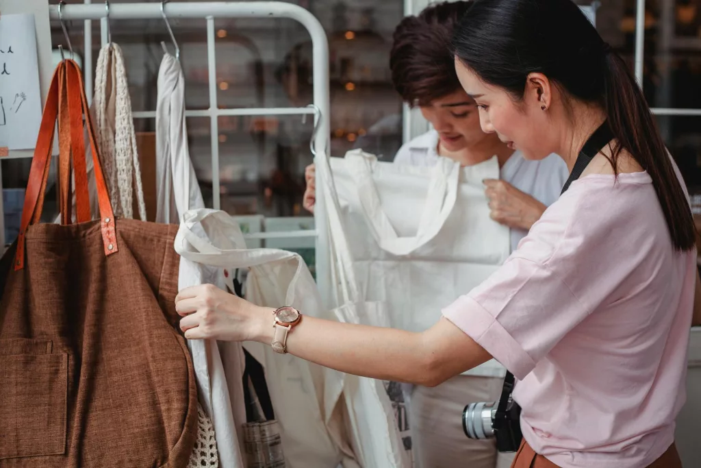 Two women shopping for ethical clothing at a local store